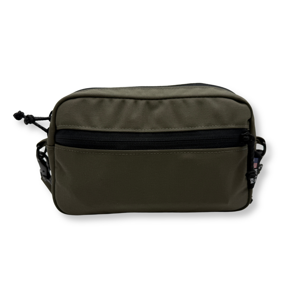 Green MAG bag with black zipper on a white background