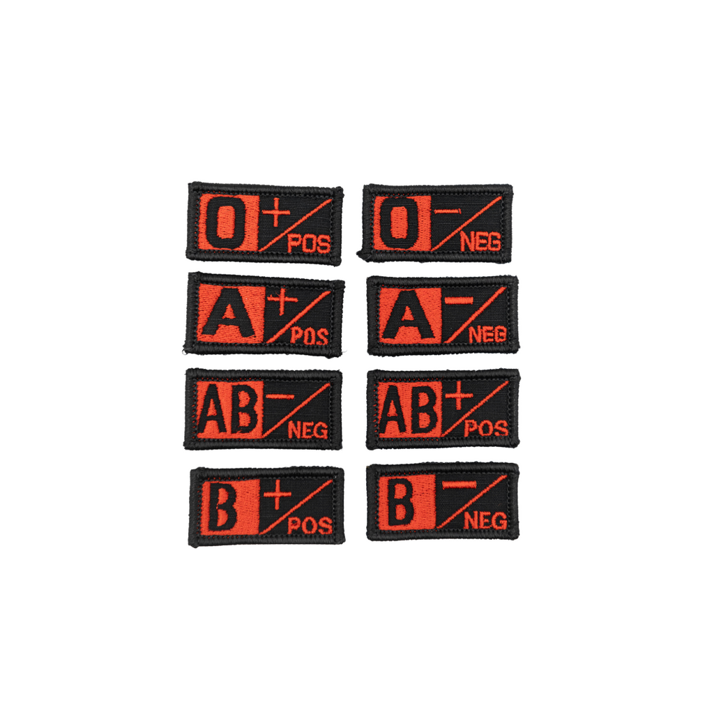 A collection of velcro patches with different blood type designs, including O+, O-, A+, A-, AB+, AB-, B+, and B-. black and red