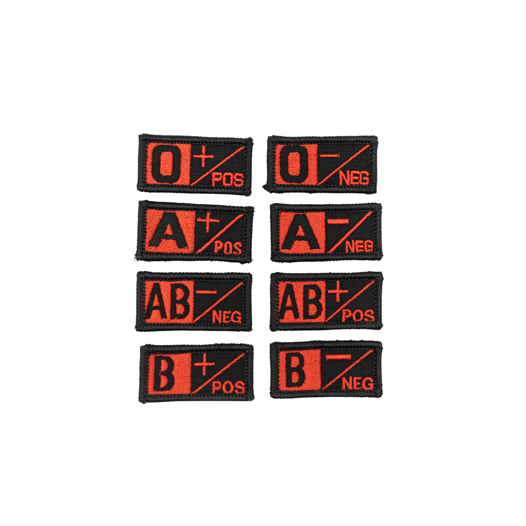 A collection of velcro patches with different blood type designs, including O+, O-, A+, A-, AB+, AB-, B+, and B-. black and red