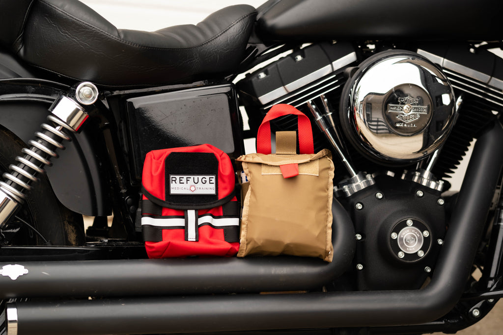 Refuge Medical BikerFAK First Aid Kit - Red, Inner and outer sitting on a motorcycle