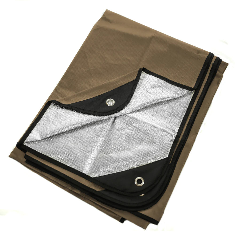 A tan survival blanket with reverse reflective silver back and black reinforced tie-down grommets, displayed on a white background.