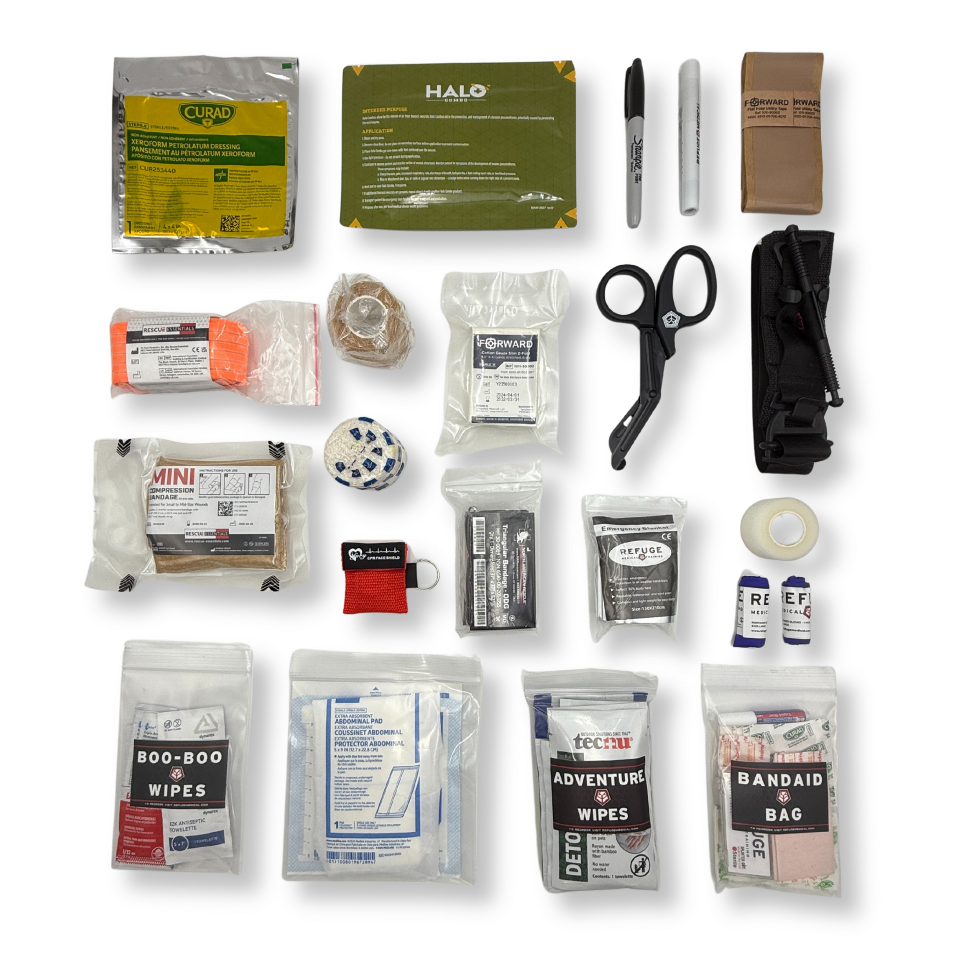 Collection of first aid supplies including bandages, scissors, and other medical items on a white background